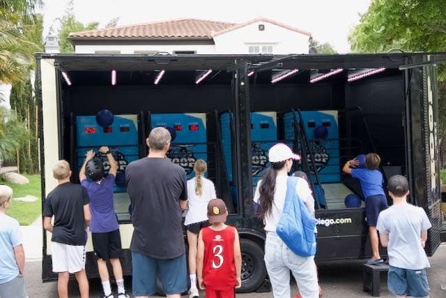 Backyard crowd taking turns on the arcade games