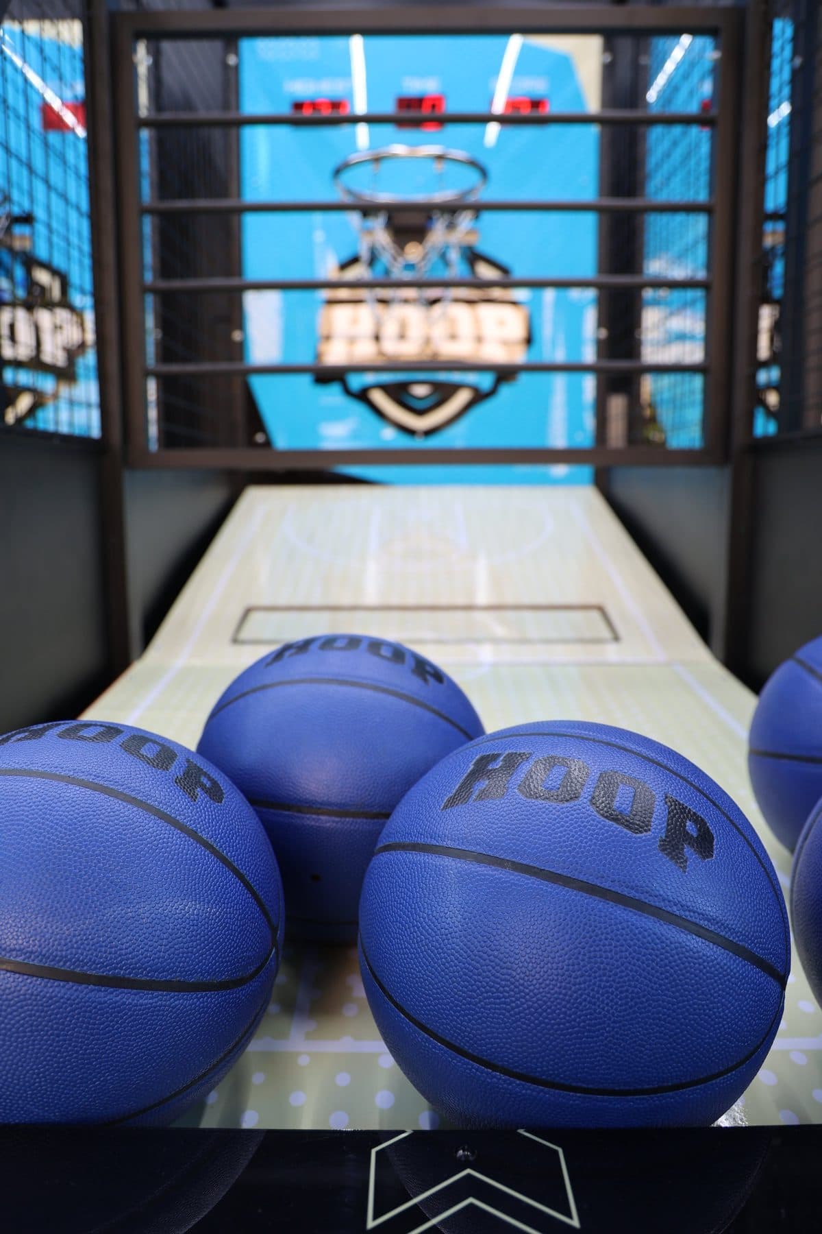 Blue HOOP branded basketballs stacked in the trailer