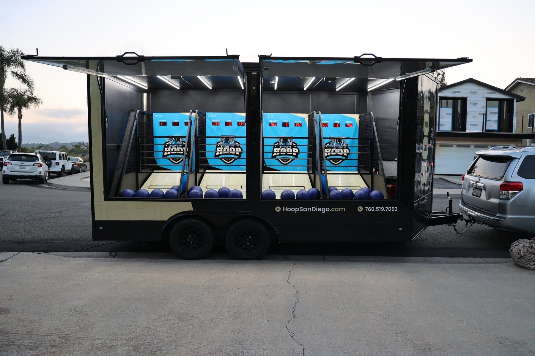 Hoop San Diego mobile arcade basketball trailer fully open with all four games ready to play